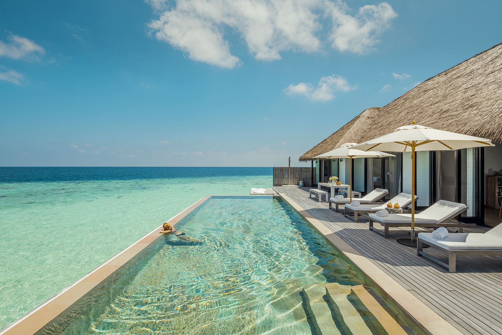 Sunbathing from an oceanfront suite at The Ritz-Carlton Maldives, Fari Islands