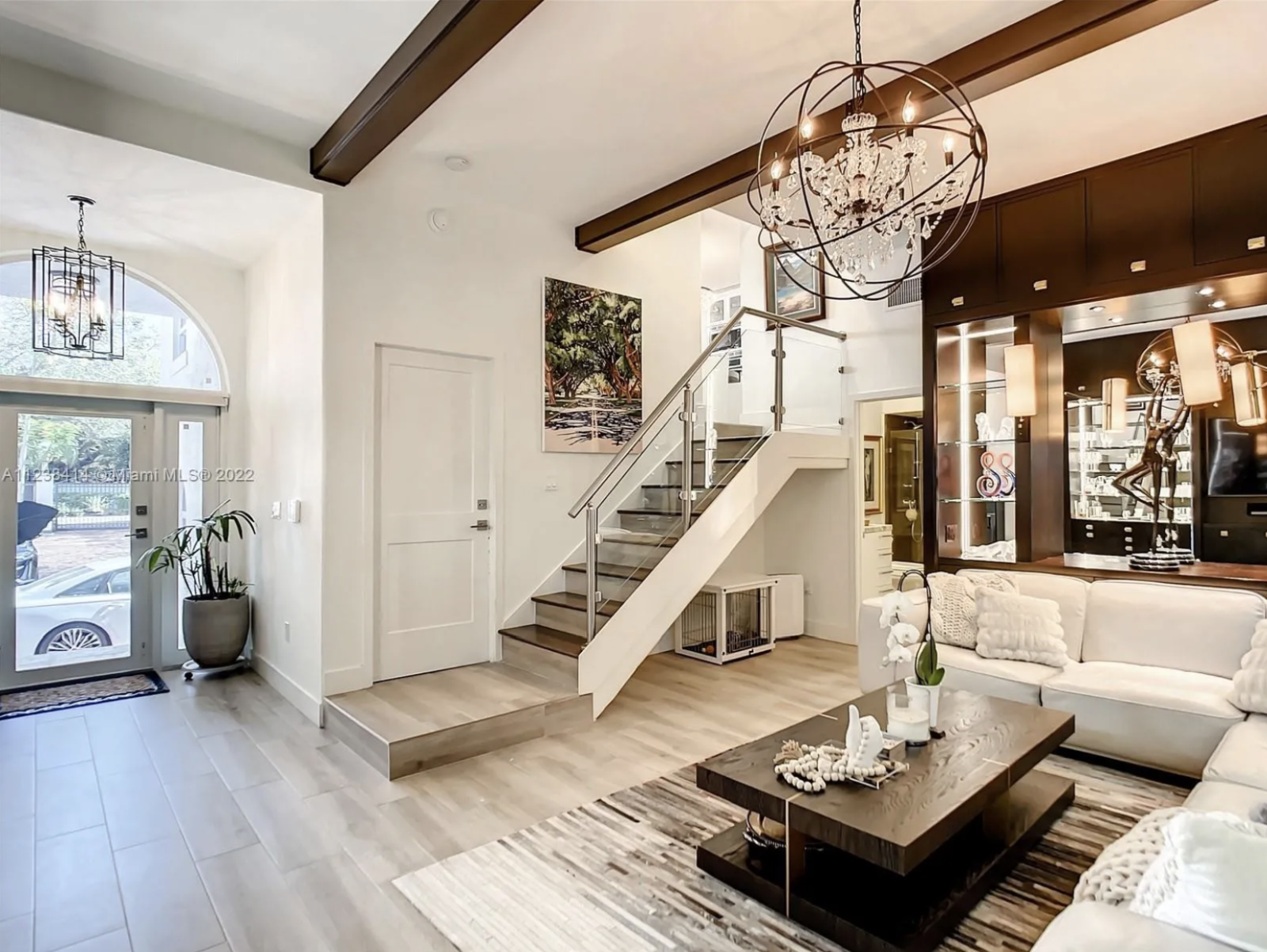 Maura Rossi, an accomplished interior designer, standing in a stylishly decorated living room she designed, exemplifying her elegant and innovative aesthetic.