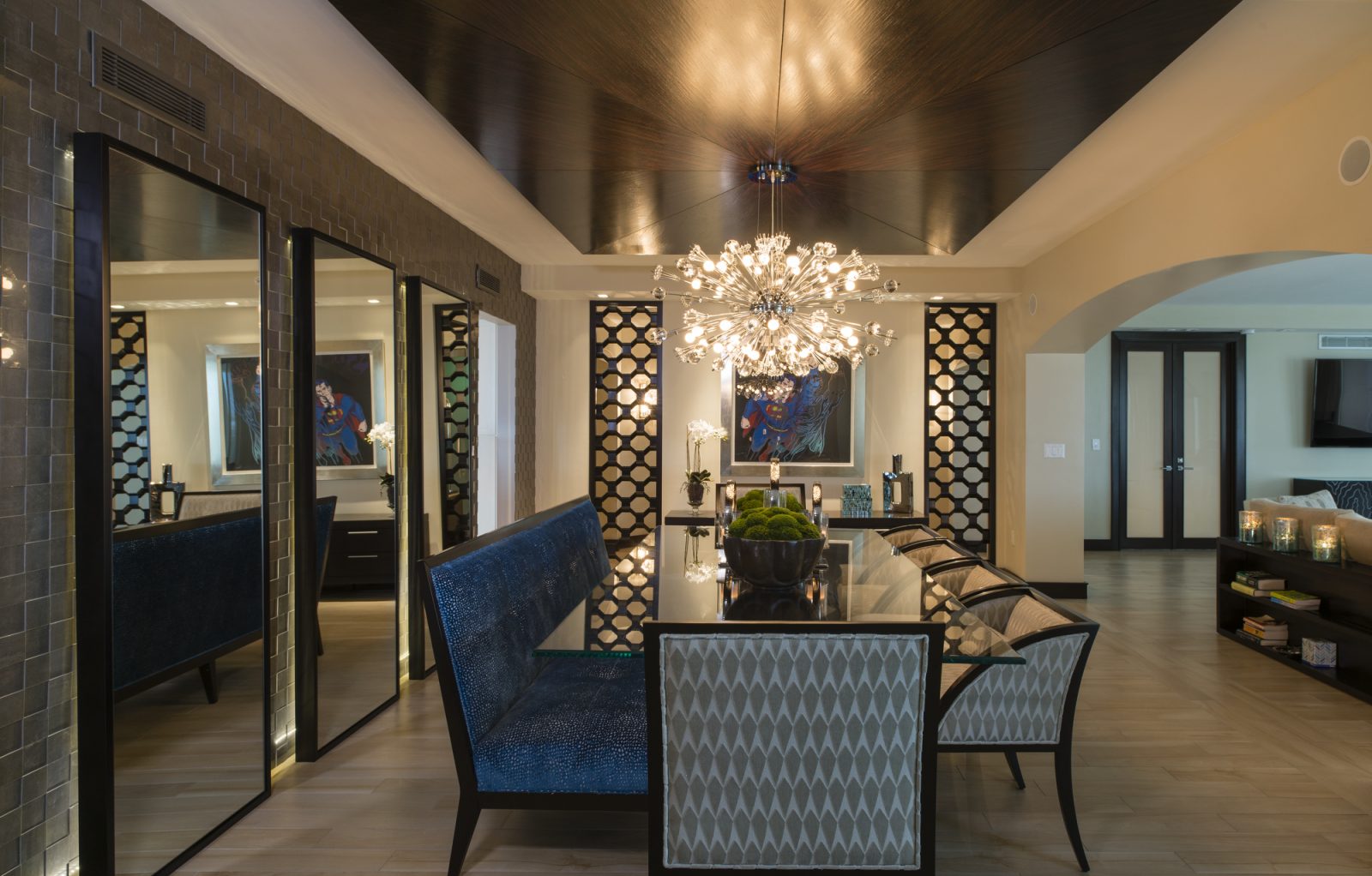 Maura Rossi, an accomplished interior designer, standing in a stylishly decorated living room she designed, exemplifying her elegant and innovative aesthetic.