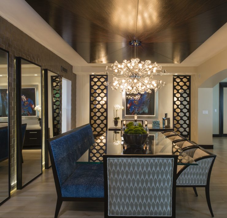 Maura Rossi, an accomplished interior designer, standing in a stylishly decorated living room she designed, exemplifying her elegant and innovative aesthetic.