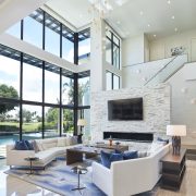 Gage Hartung, a professional and focused interior designer, reviewing blueprints and fabric samples in his well-organized office, surrounded by elegant and modern design elements.