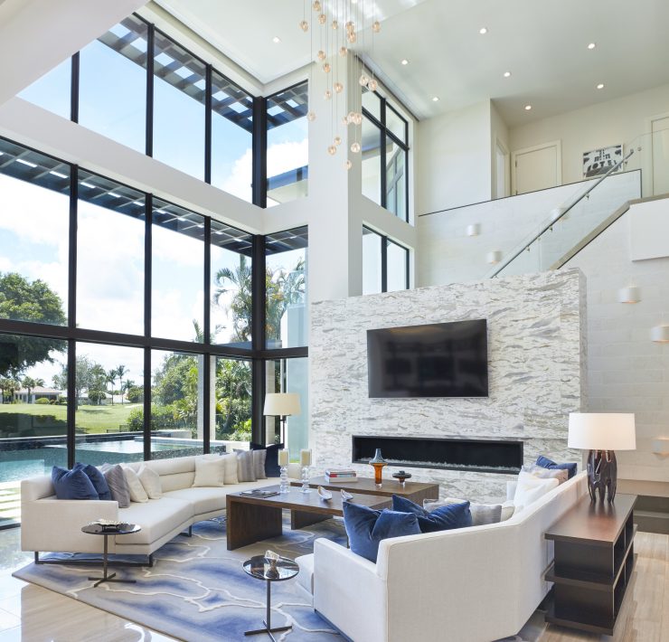 Gage Hartung, a professional and focused interior designer, reviewing blueprints and fabric samples in his well-organized office, surrounded by elegant and modern design elements.