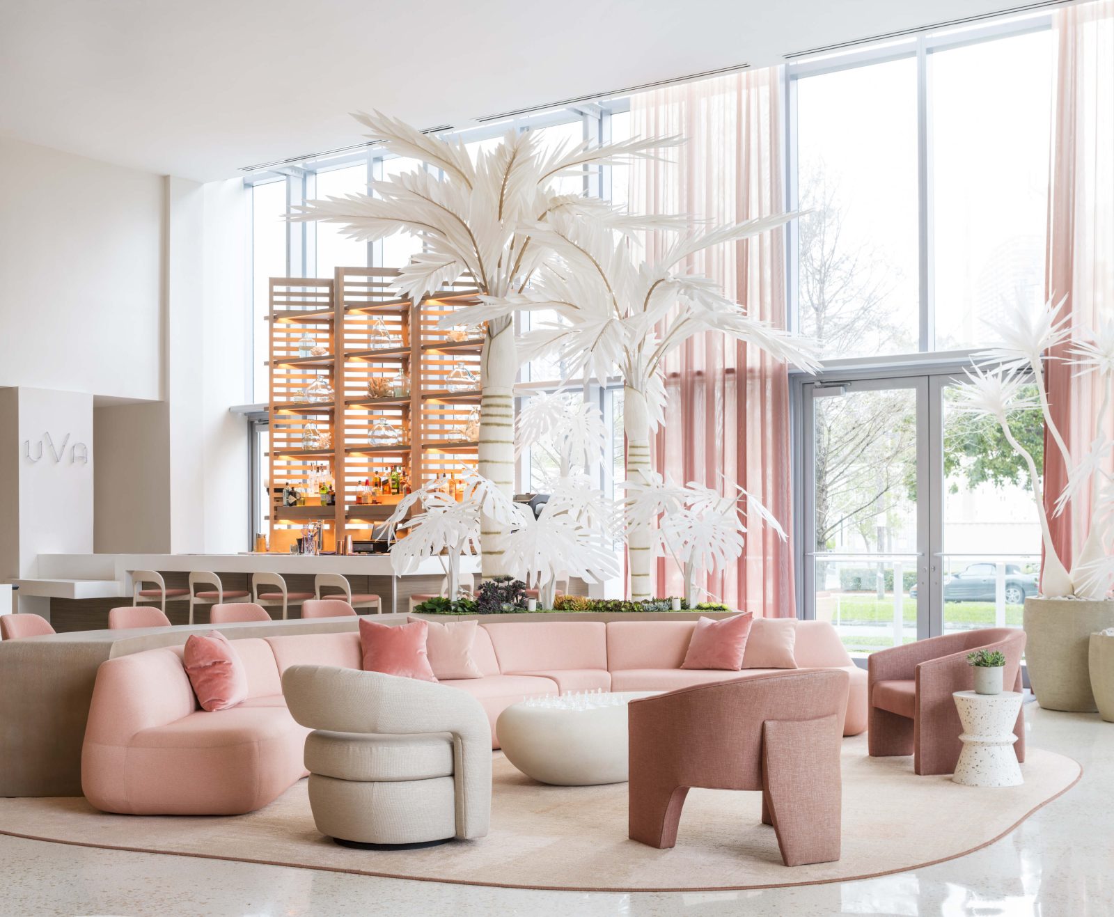 UVA Lounge at The Goodtime Hotel featuring soft pink seating and tropical-inspired décor. Caption: Pastel palettes and tropical elegance blend at UVA Lounge, The Goodtime Hotel’s signature social space.