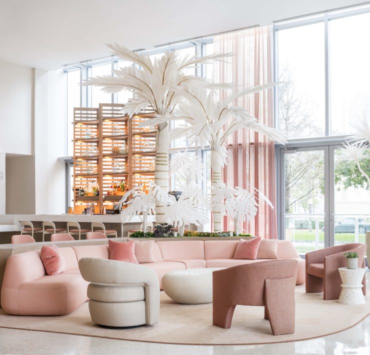 UVA Lounge at The Goodtime Hotel featuring soft pink seating and tropical-inspired décor. Caption: Pastel palettes and tropical elegance blend at UVA Lounge, The Goodtime Hotel’s signature social space.