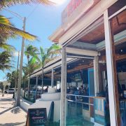 Front view of Bo’s Beach in Fort Lauderdale, a beachfront restaurant with a tropical vibe, open-air terrace, and palm trees under the Florida sun.