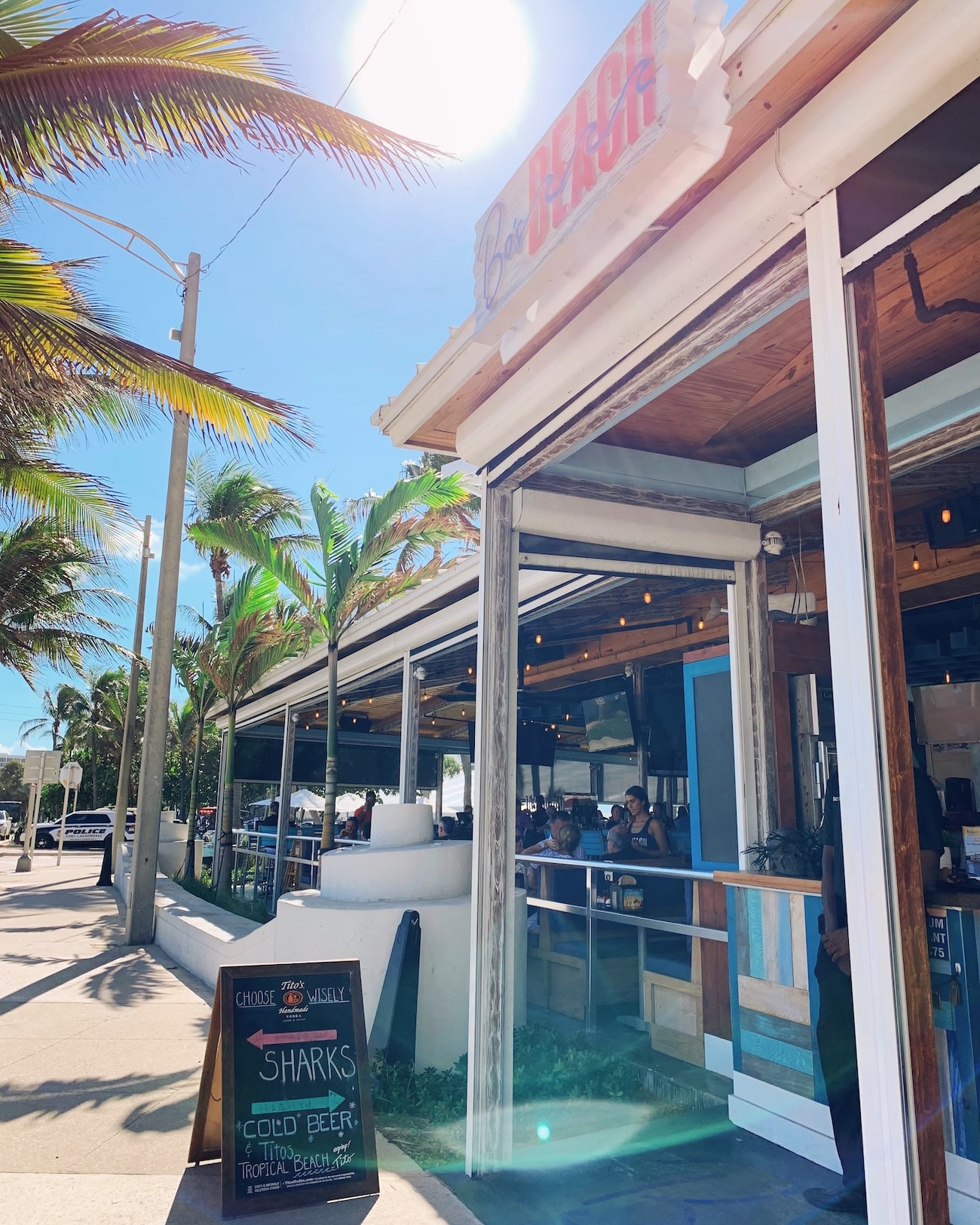 Front view of Bo’s Beach in Fort Lauderdale, a beachfront restaurant with a tropical vibe, open-air terrace, and palm trees under the Florida sun.