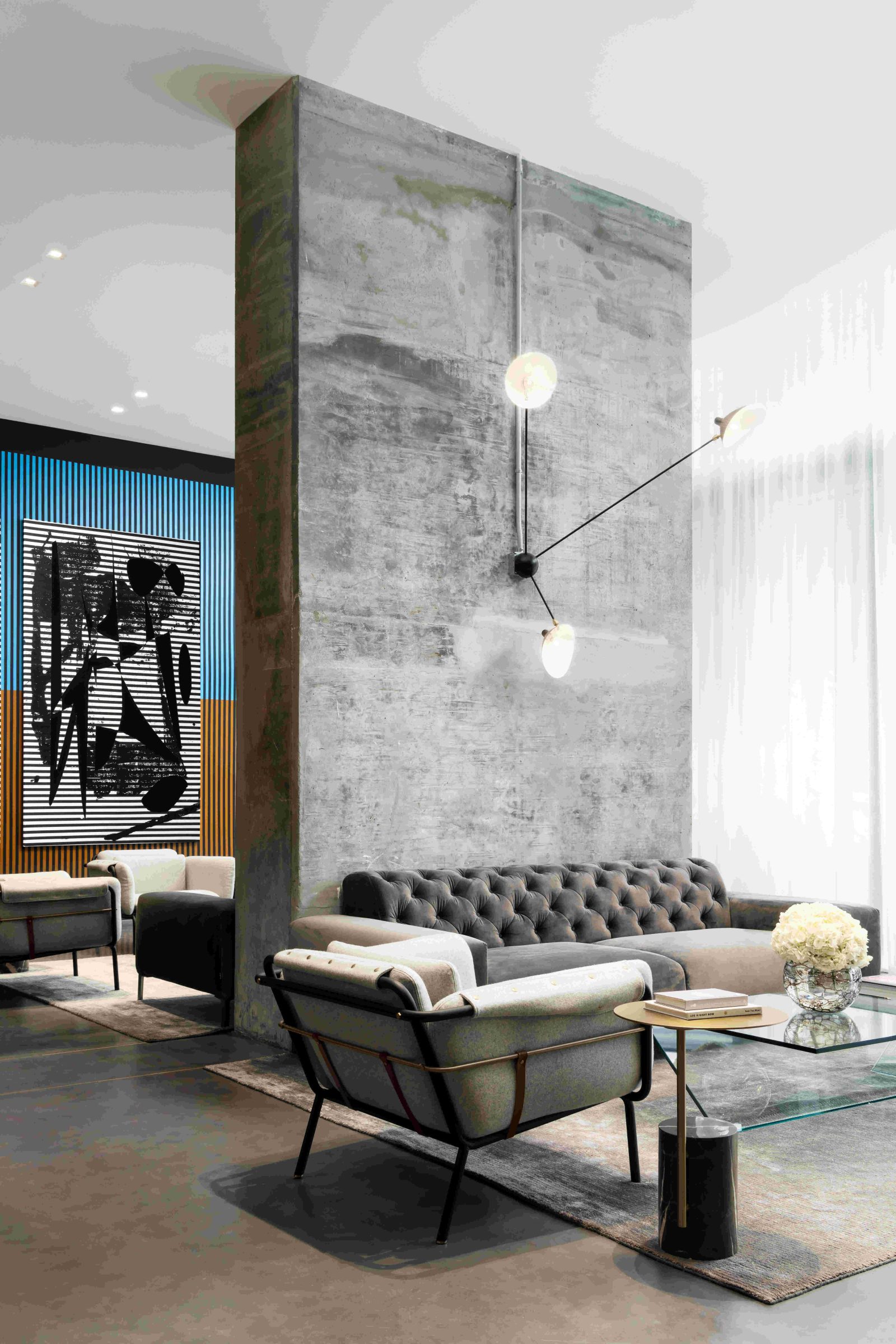 Contemporary living room with minimalist furniture and wall art in Miami’s Design District. Caption: A modern lounge reflecting Miami’s artistic design aesthetic — where minimalism meets comfort.