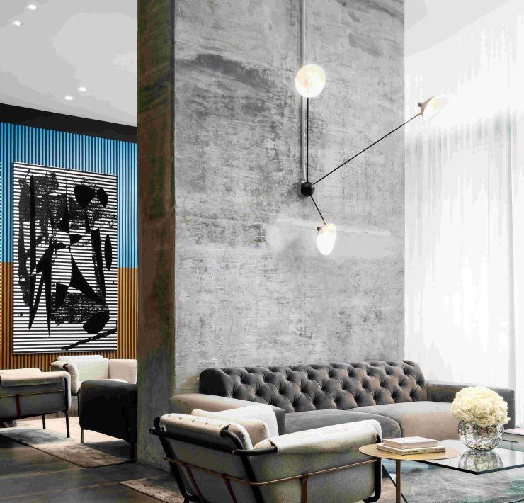 Contemporary living room with minimalist furniture and wall art in Miami’s Design District. Caption: A modern lounge reflecting Miami’s artistic design aesthetic — where minimalism meets comfort.