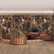 Lounge area at Ocean Key Resort & Spa showcasing bold tropical wallpaper, rattan chairs, and warm wood finishes.