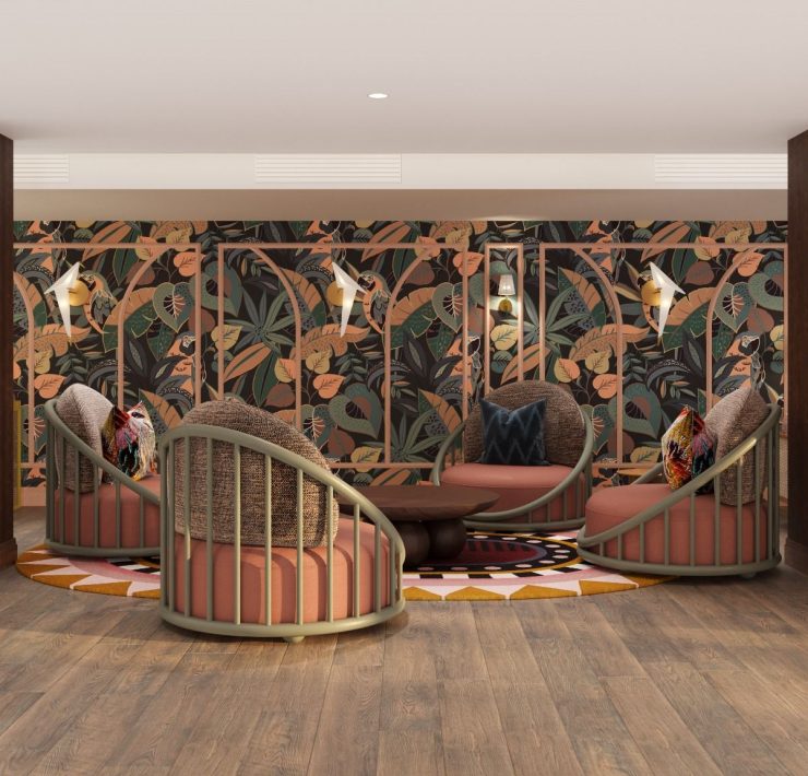 Lounge area at Ocean Key Resort & Spa showcasing bold tropical wallpaper, rattan chairs, and warm wood finishes.
