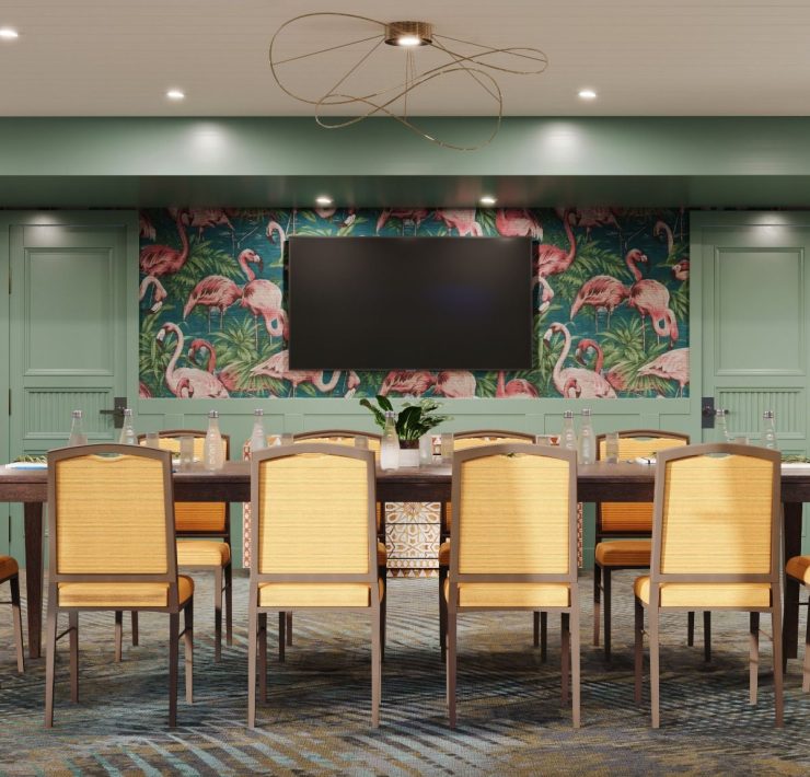 White Ibis Boardroom at Ocean Key Resort featuring flamingo wallpaper and elegant seating for meetings with ocean views.
