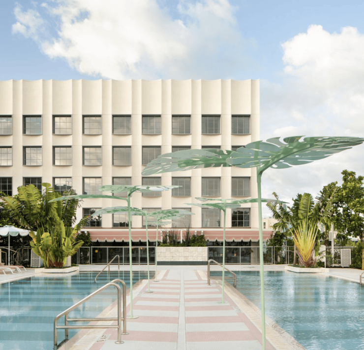 Rooftop pool area at The Goodtime Hotel Miami with palm trees and pastel tones. Caption: The Goodtime Hotel’s rooftop pool captures Miami’s sun-drenched, carefree spirit.