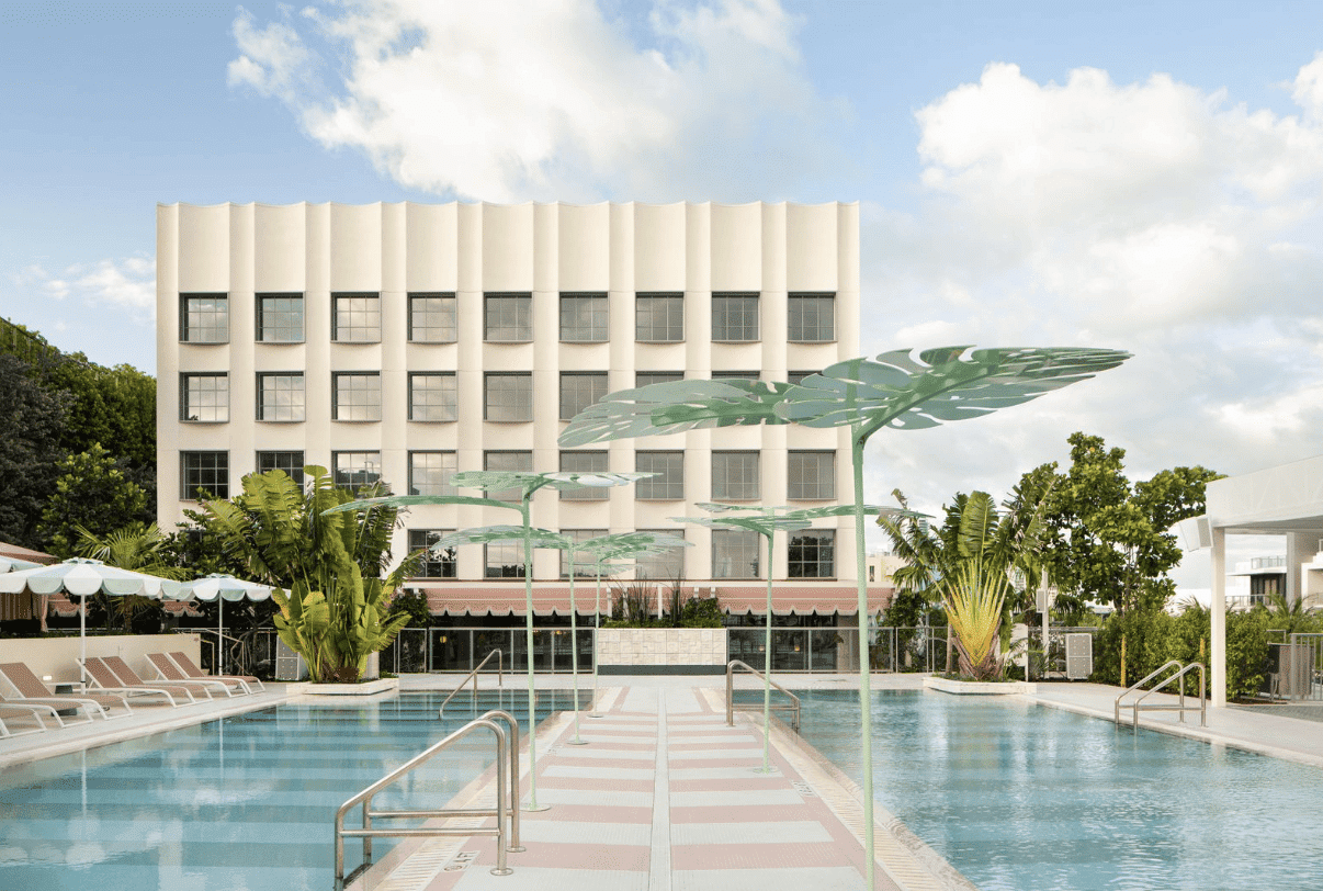 Rooftop pool area at The Goodtime Hotel Miami with palm trees and pastel tones. Caption: The Goodtime Hotel’s rooftop pool captures Miami’s sun-drenched, carefree spirit.