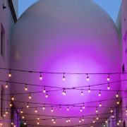 The Betsy Orb sculpture illuminated in purple light connecting The Betsy Hotel’s two buildings on Ocean Drive, Miami Beach.