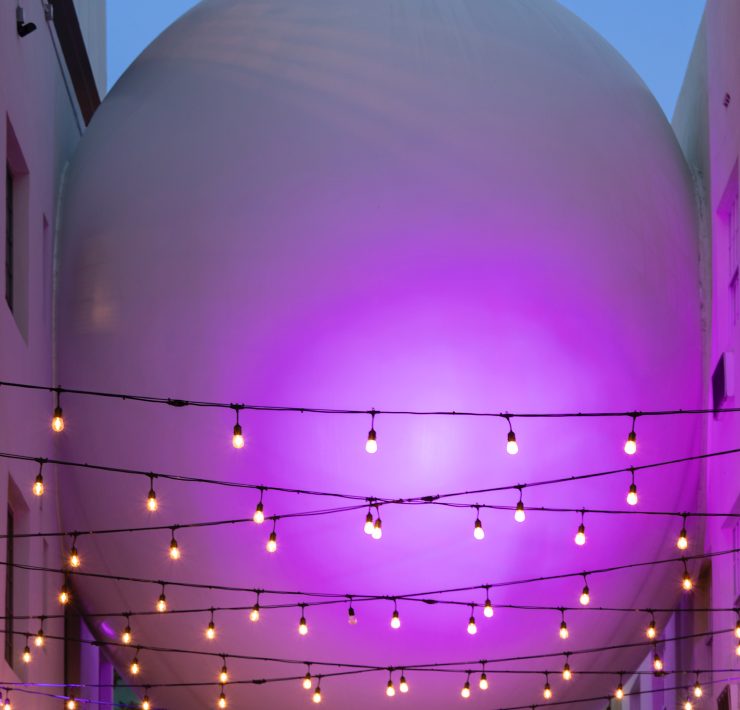 The Betsy Orb sculpture illuminated in purple light connecting The Betsy Hotel’s two buildings on Ocean Drive, Miami Beach.