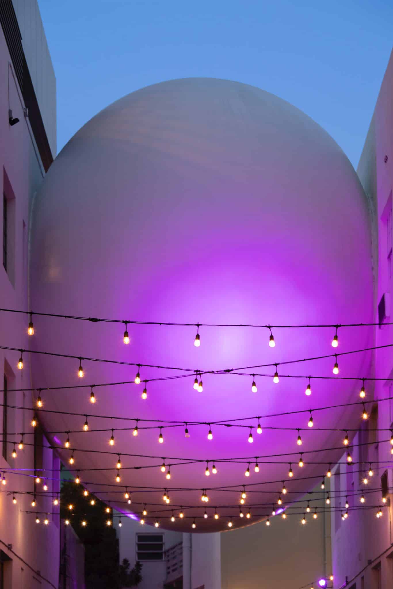The Betsy Orb sculpture illuminated in purple light connecting The Betsy Hotel’s two buildings on Ocean Drive, Miami Beach.