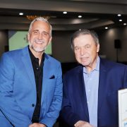 Two judges at the American Heritage Schools Business Incubator Pitch Challenge in Fort Lauderdale, celebrating student entrepreneurship and innovation.
