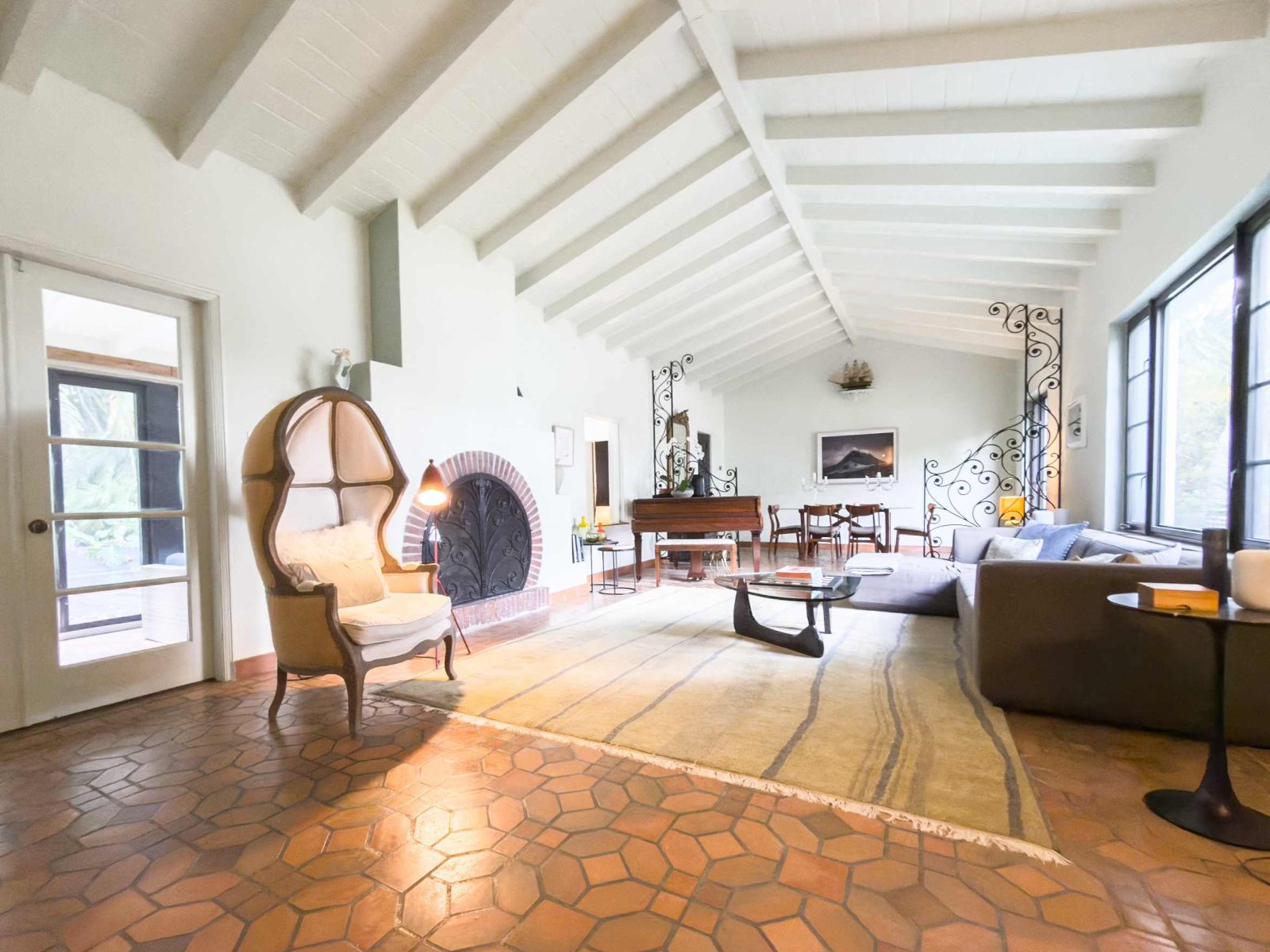 Spacious living room with vaulted ceilings and signature ziggurat-style arches inside the historic Belle Meade Art Deco residence.