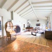 Spacious living room with vaulted ceilings and signature ziggurat-style arches inside the historic Belle Meade Art Deco residence.