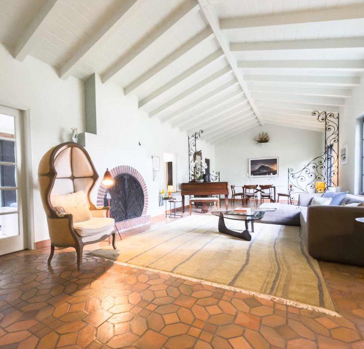 Spacious living room with vaulted ceilings and signature ziggurat-style arches inside the historic Belle Meade Art Deco residence.