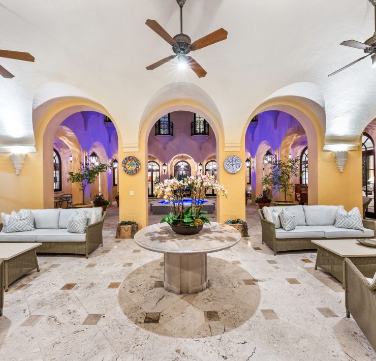 Interior living room with vaulted ceilings, arched walkways, and elegant seating inside Armando Codina’s Coral Gables residence.