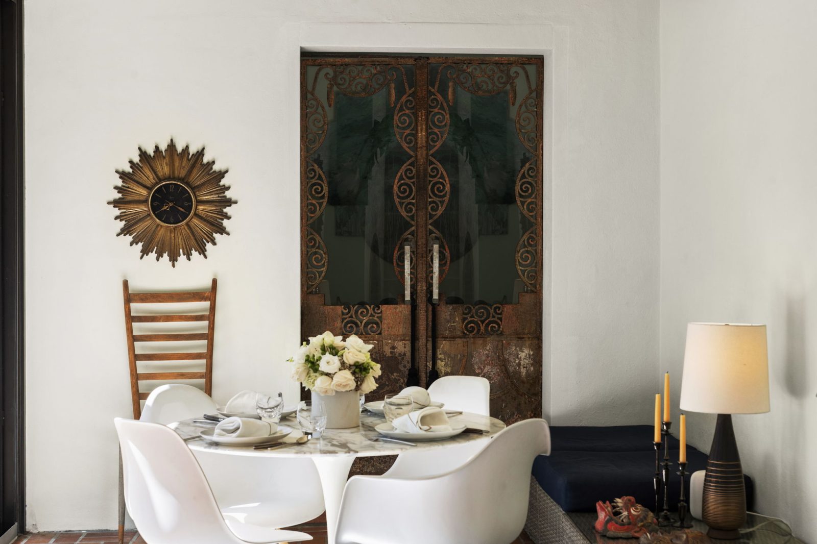 Intimate dining nook with ornate iron doors and warm Mediterranean-inspired design in Belle Meade’s historic home.