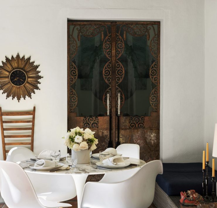 Intimate dining nook with ornate iron doors and warm Mediterranean-inspired design in Belle Meade’s historic home.