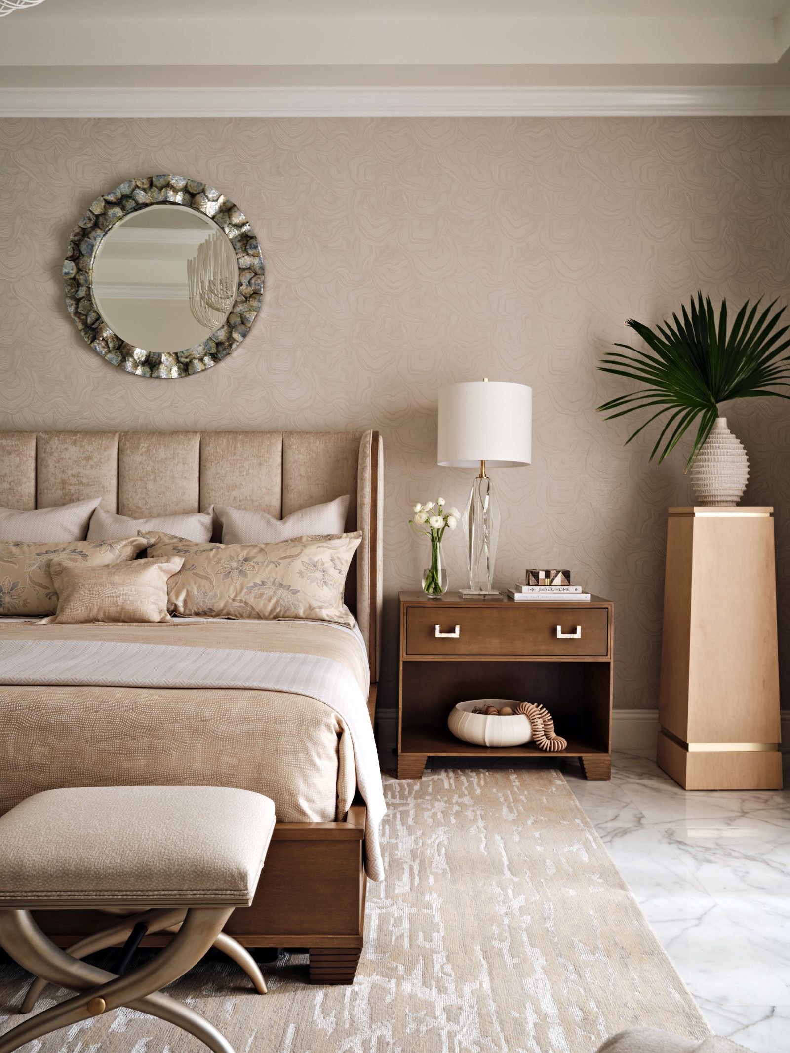 Sophisticated primary bedroom with tufted headboard, neutral palette, and elegant layered textures by Maritza Capiro.