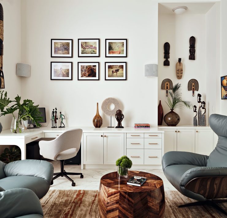Contemporary home office with gallery wall, blue chairs, and eclectic decor by Maritza Capiro.