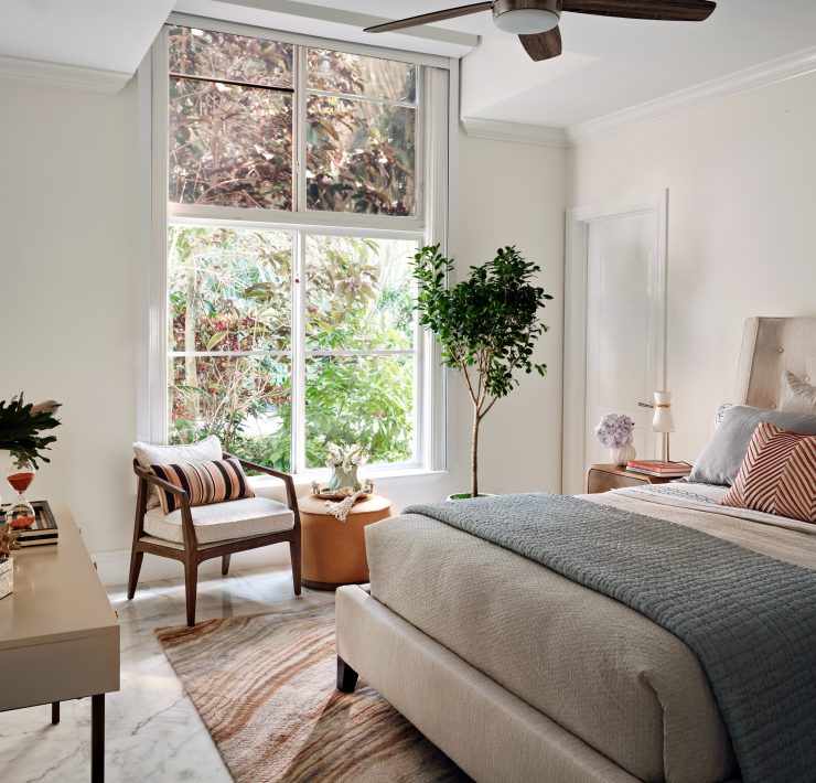 Calming bedroom featuring layered textures, light wood tones, and elegant soft furnishings.