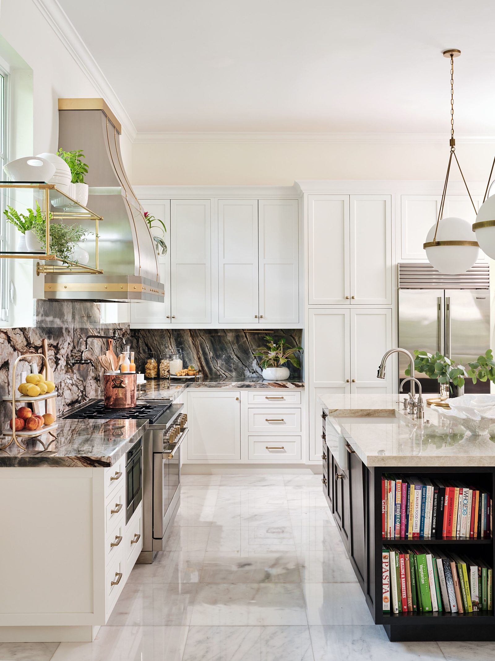 Modern white kitchen with marble backsplash, pendant lighting, and open shelving design.