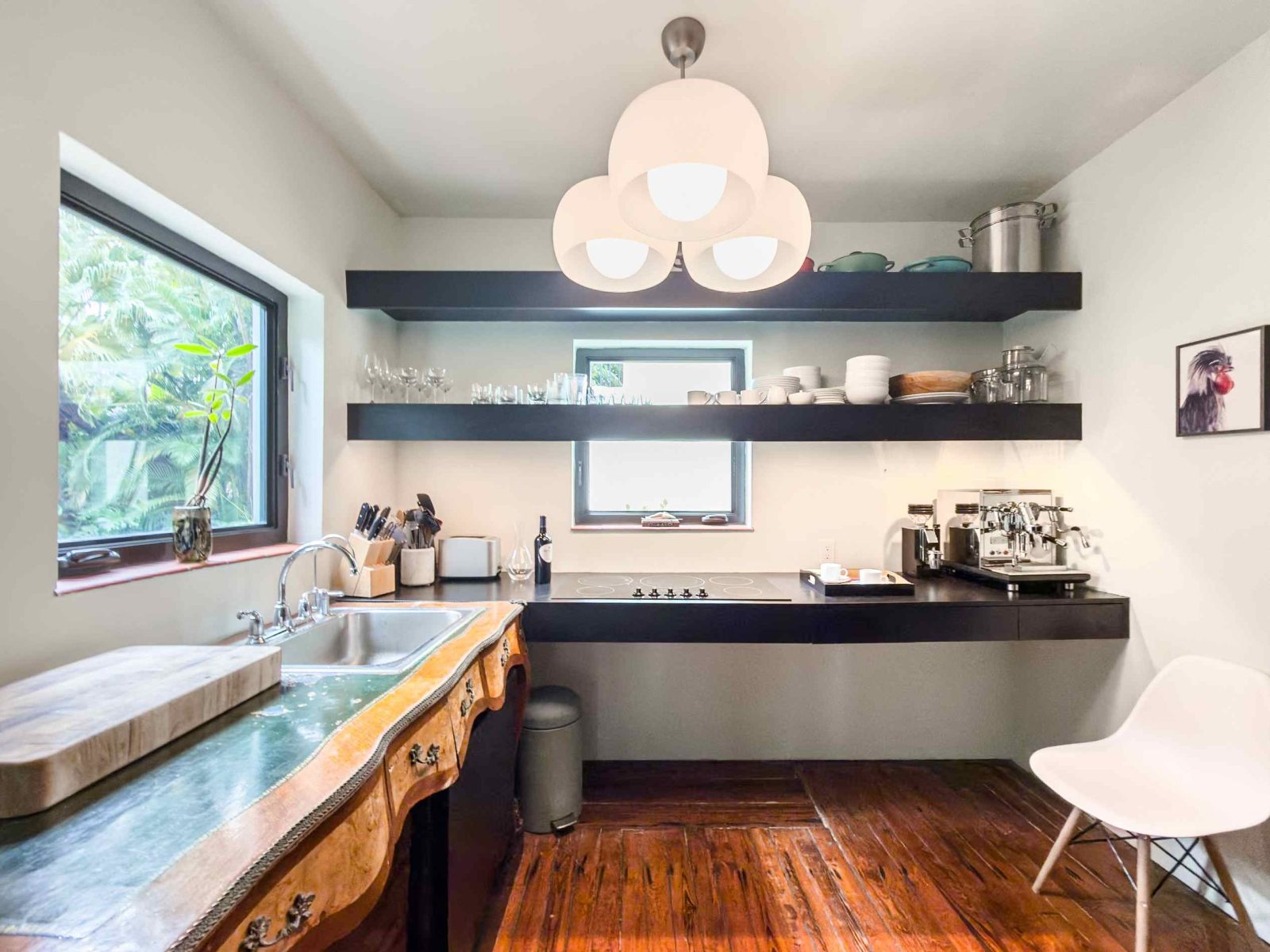 Modern kitchen featuring natural wood details and contemporary lighting inside the restored Belle Meade Deco home.
