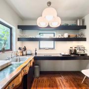 Modern kitchen featuring natural wood details and contemporary lighting inside the restored Belle Meade Deco home.