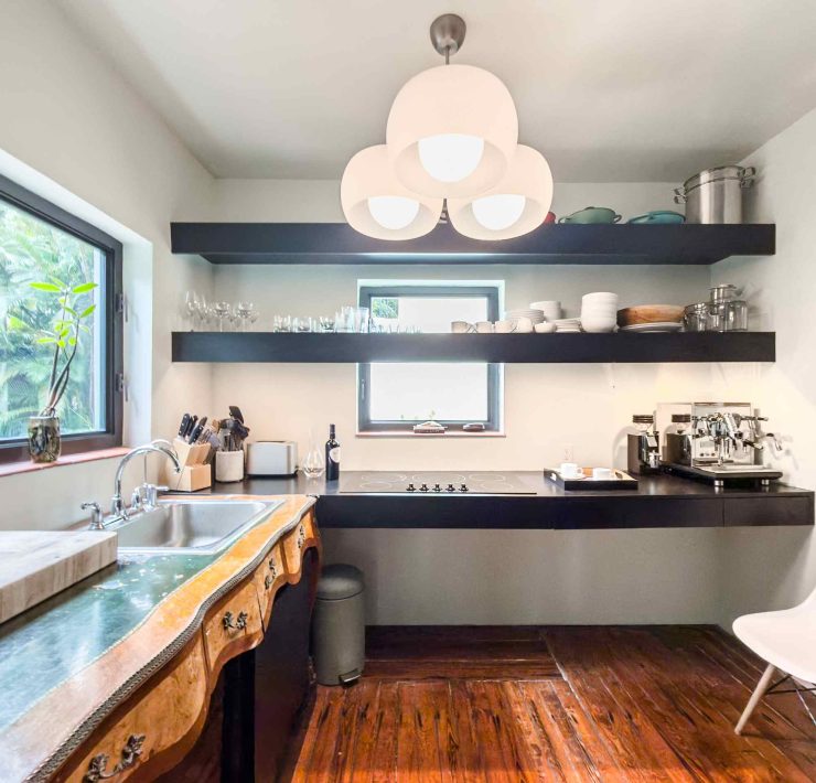 Modern kitchen featuring natural wood details and contemporary lighting inside the restored Belle Meade Deco home.