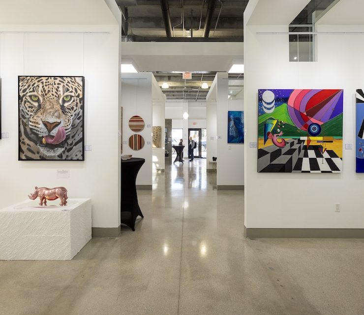 Corridor view of CHROMA 2025 exhibition at Lucid Design District featuring colorful, abstract artworks and installations.