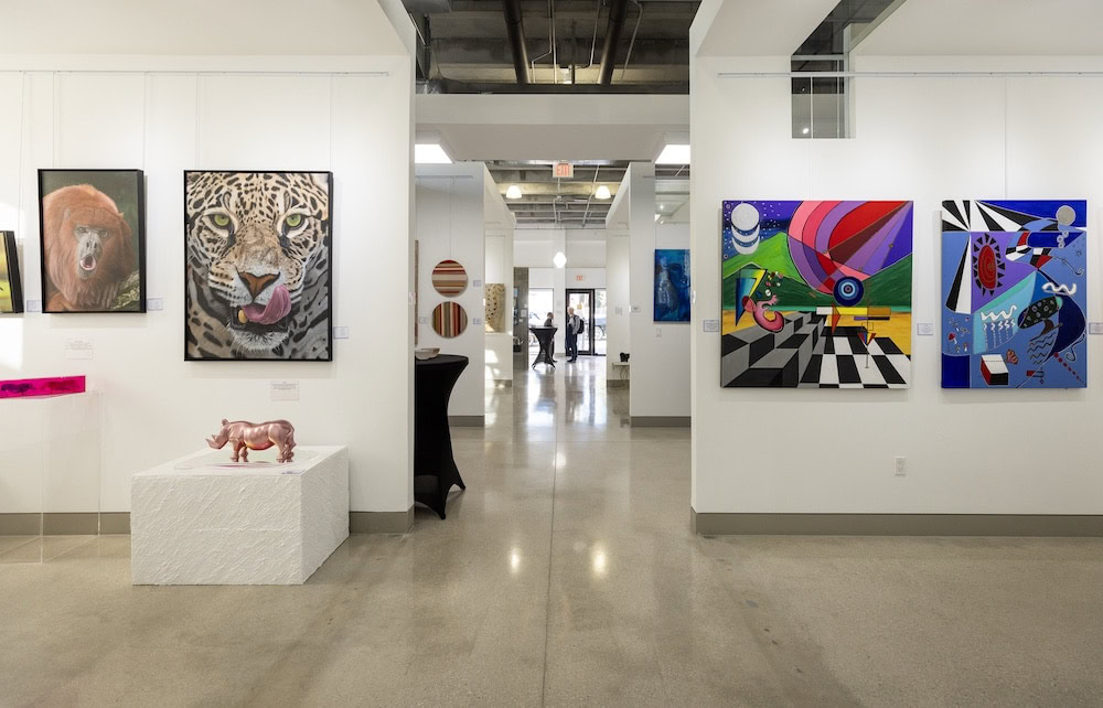 Corridor view of CHROMA 2025 exhibition at Lucid Design District featuring colorful, abstract artworks and installations.