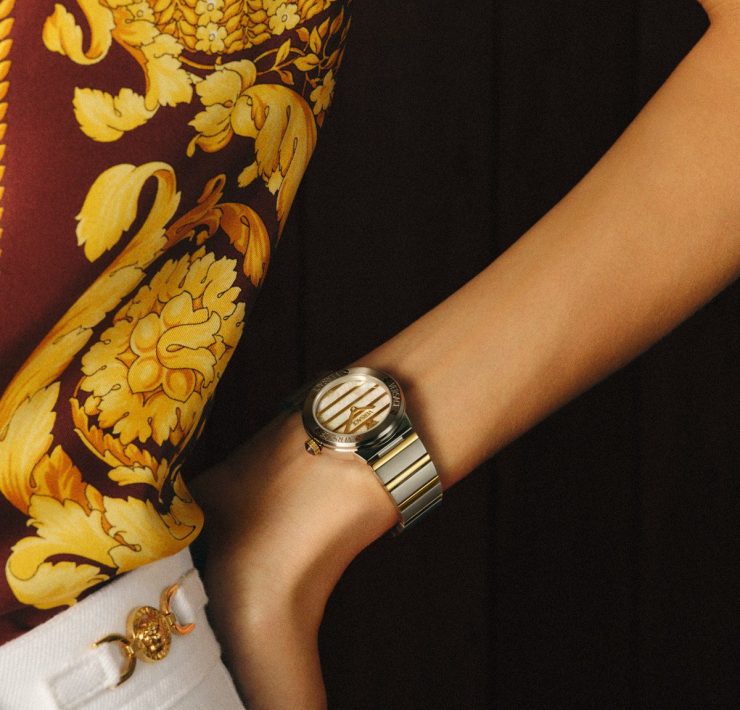 Gold Versace FW25 watch paired with a signature baroque print shirt, blending heritage and modern luxury.