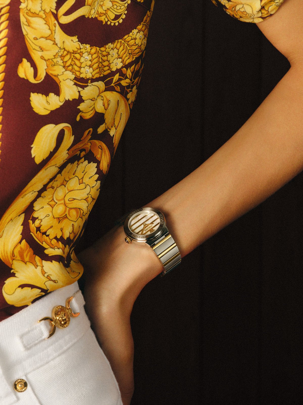 Gold Versace FW25 watch paired with a signature baroque print shirt, blending heritage and modern luxury.