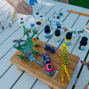 Guest painting colorful alebrijes during a traditional Mexican art workshop at Mar del Cabo