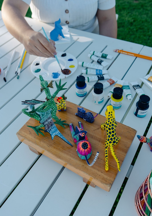 Guest painting colorful alebrijes during a traditional Mexican art workshop at Mar del Cabo