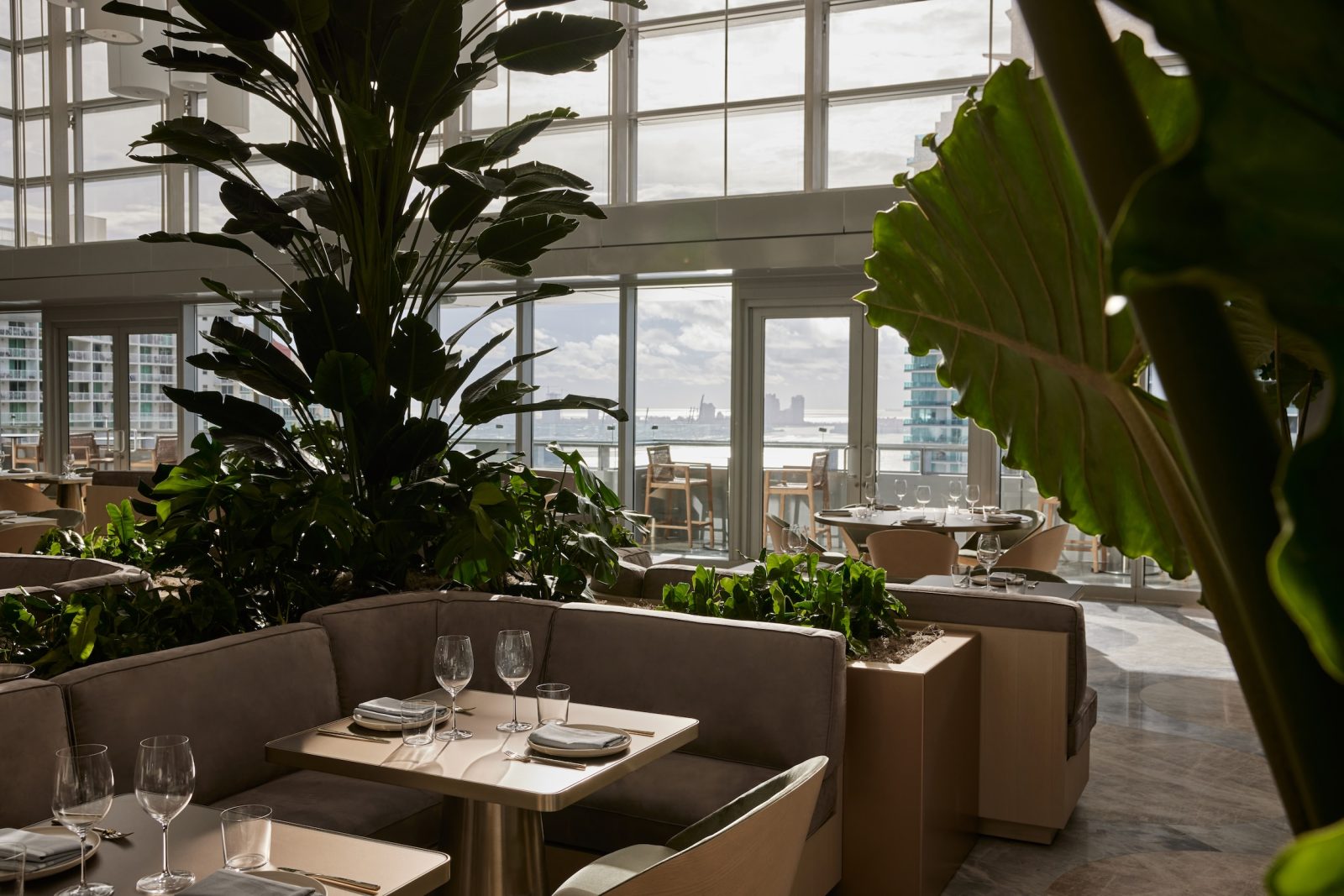Interior of ADRIFT Mare restaurant with Biscayne Bay view at Hotel AKA Brickell.