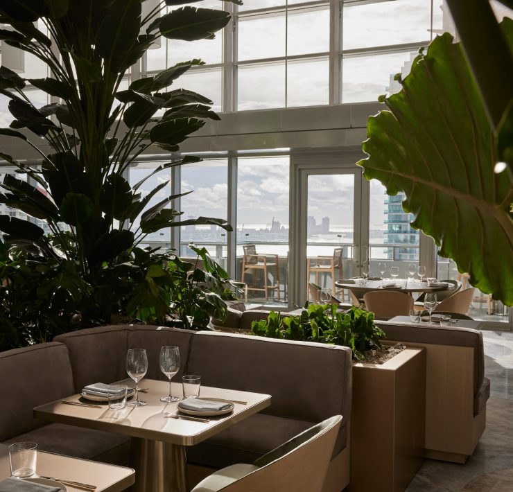 Interior of ADRIFT Mare restaurant with Biscayne Bay view at Hotel AKA Brickell.