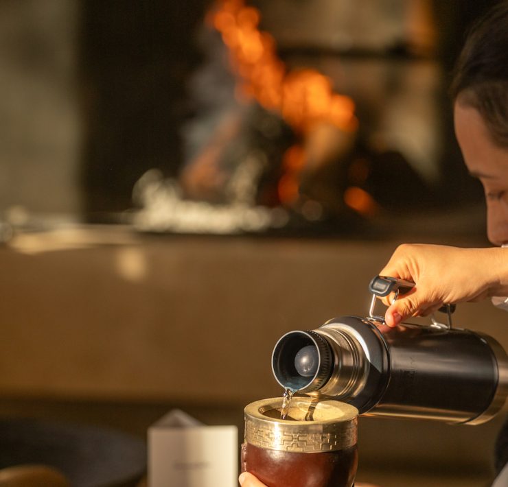 Guest preparing and serving mate tea during a cultural ritual at SB Winemaker’s House in Mendoza.