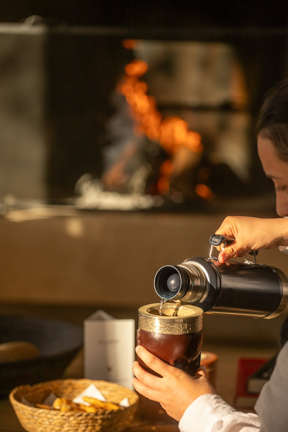 Guest preparing and serving mate tea during a cultural ritual at SB Winemaker’s House in Mendoza.