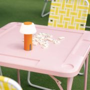 Pink domino table setup at Lakou Miami’s outdoor lounge, featuring playful decor and vibrant Caribbean-inspired design in Little Haiti.