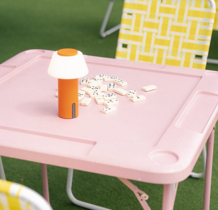 Pink domino table setup at Lakou Miami’s outdoor lounge, featuring playful decor and vibrant Caribbean-inspired design in Little Haiti.
