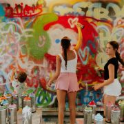 Visitors and families painting graffiti walls during interactive art workshops in Wynwood Miami.