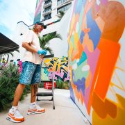 Street artist painting colorful mural at Wynwood Mural Festival during Miami Art Week 2025.”