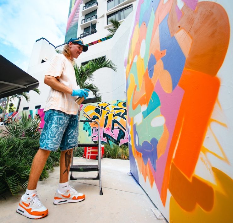 Street artist painting colorful mural at Wynwood Mural Festival during Miami Art Week 2025.”