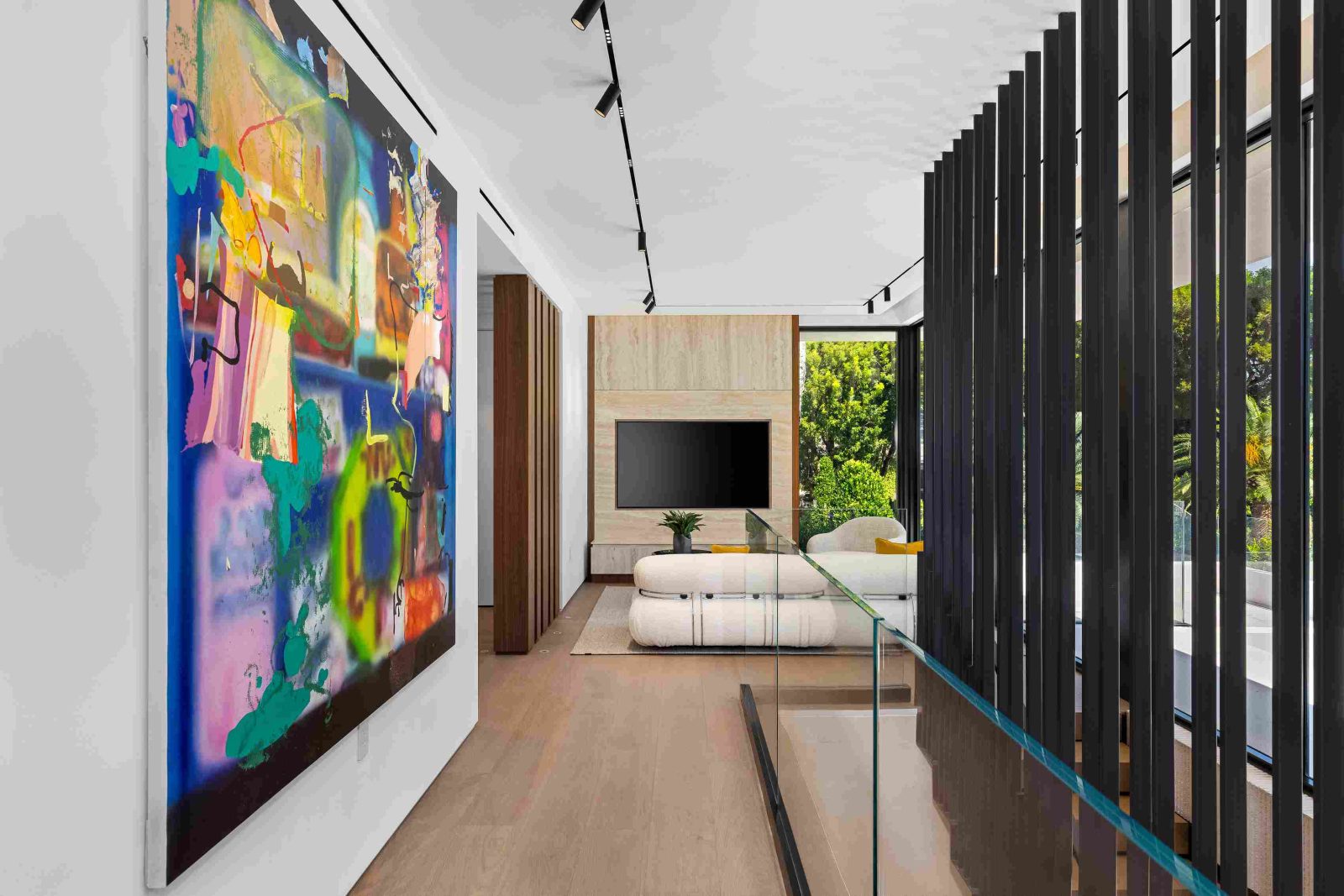 Hallway with contemporary art and minimalist design inside modern Sunset Islands home.